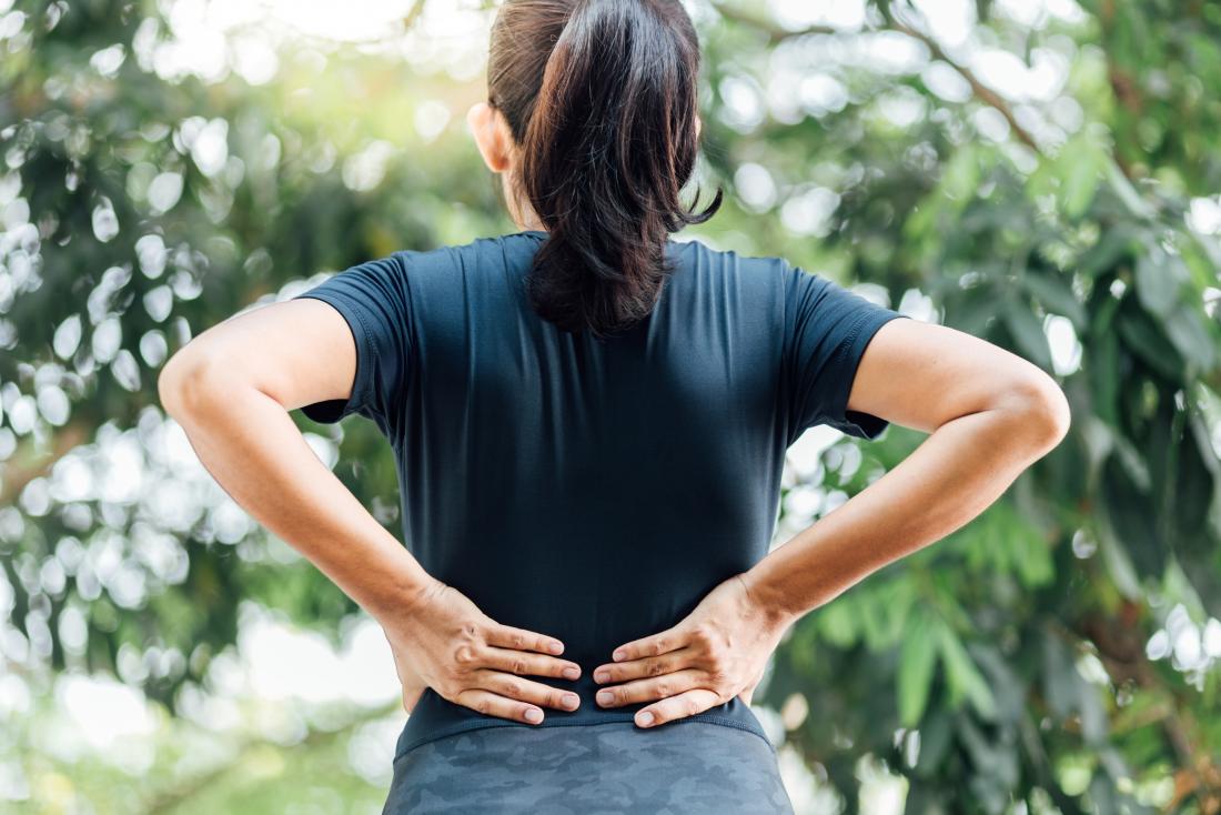 woman-holding-her-back-due-to-lower-back-and-hip-pain